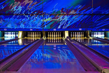 a bowling alley with an abstract wall mural