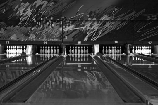 a bowling alley with an abstract wall mural